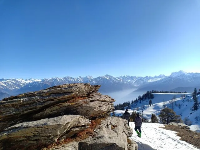 Majestic snowy mountains in Sankri capturing winter trekking vibes in the Himalayas.